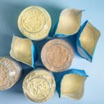 Image of bags of protein powder sat on blue background