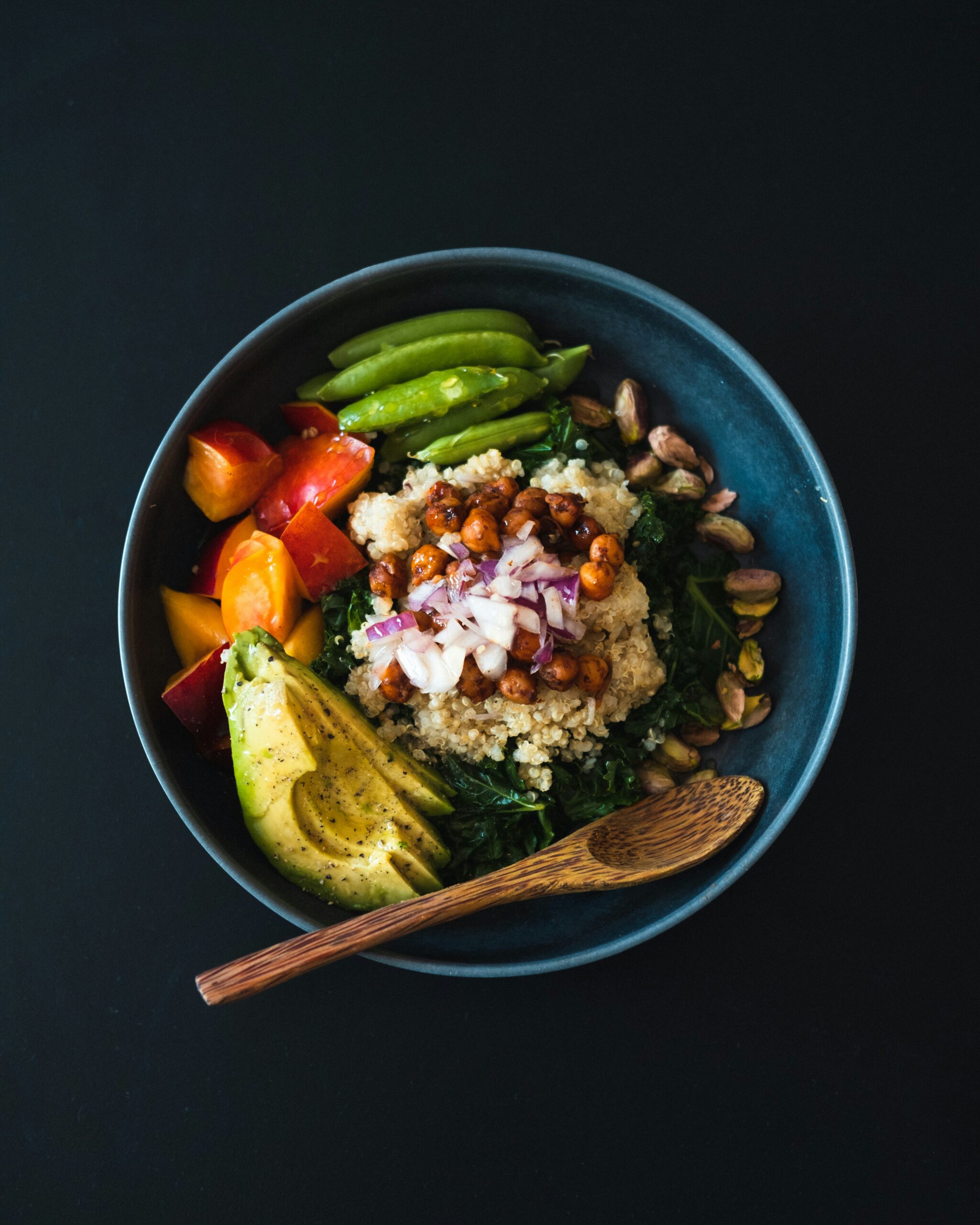photosof a-blue-bowl-filled-with-vegetables-and-a-wooden-spoon